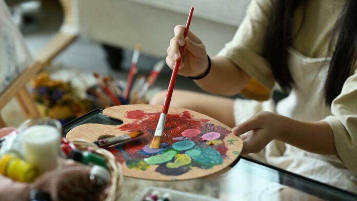 Una estudiante de pintura con sus óleos